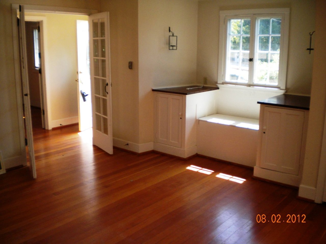 707 Moreno Road Santa Barbara, CA 93103 - Photo 3 of 11 an empty room with wooden floor and windows