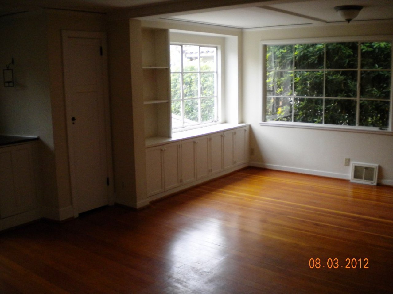 707 Moreno Road Santa Barbara, CA 93103 - Photo 4 of 11 a view of an empty room with wooden floor and a window