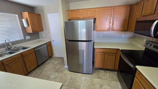 a kitchen with a refrigerator and a sink