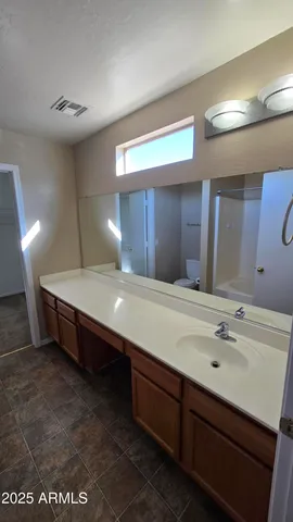 a spacious bathroom with a sink and a mirror