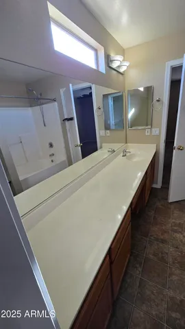 a bathroom with a double vanity sink and a mirror