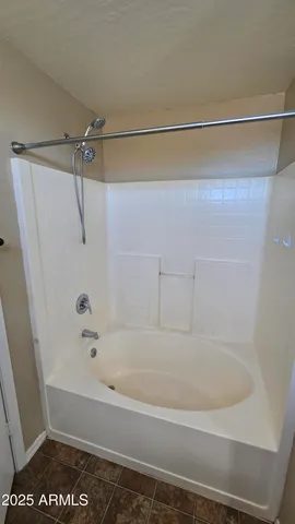 a bathroom with a shower and a bath tub