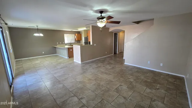 a view of a kitchen with a sink and a refrigerator
