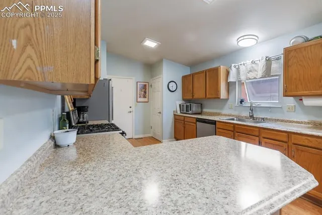 a kitchen with stainless steel appliances granite countertop a sink stove and cabinets