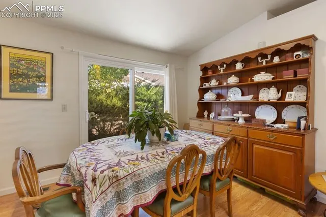 a kitchen with a table chairs and a wooden floor