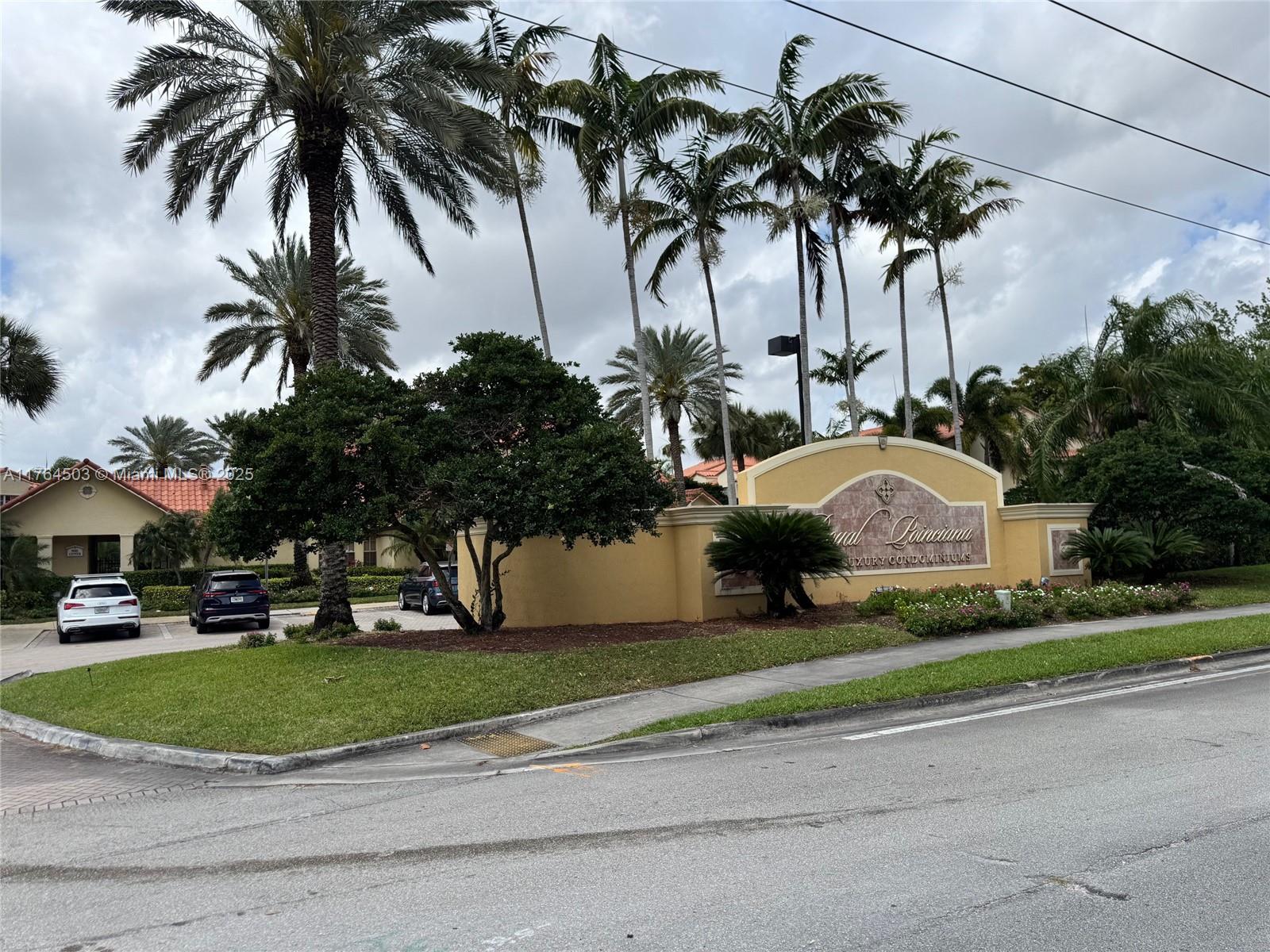 a front view of multi story residential apartment building with yard and green space