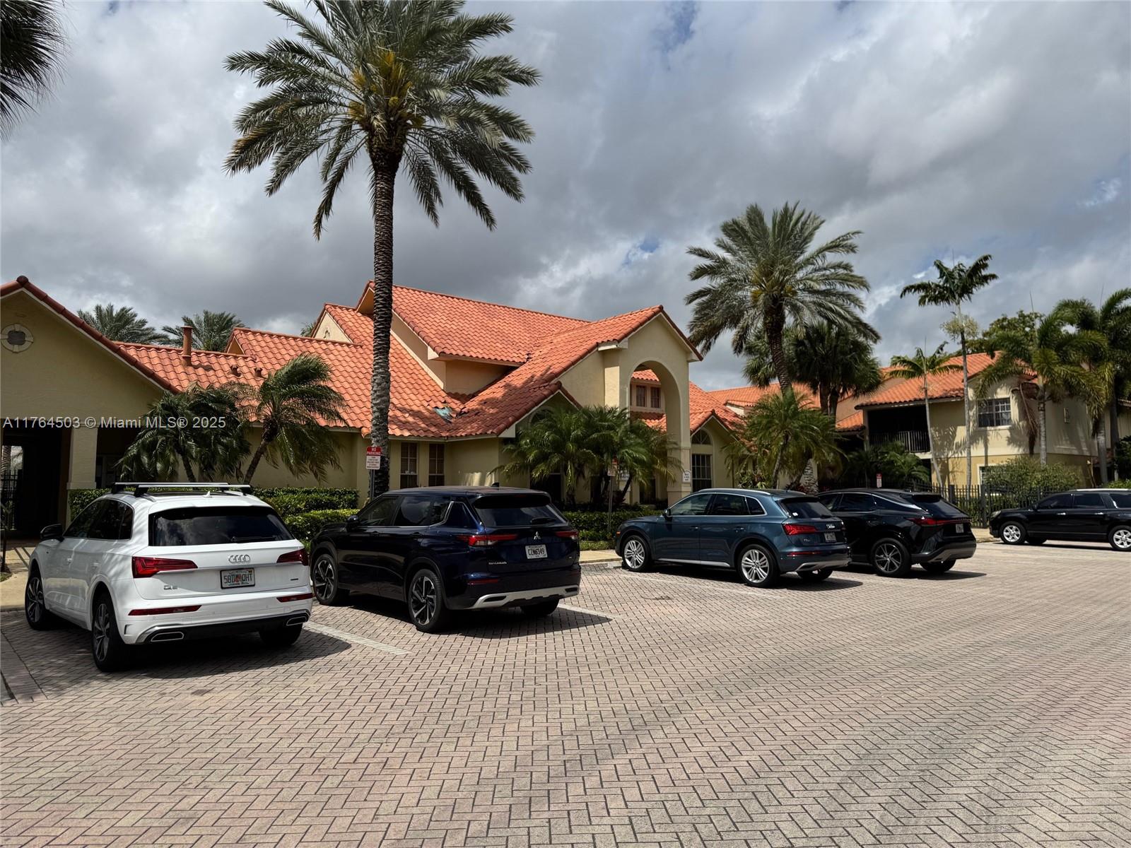 Royal Poinciana Condominium Pompano Beach, FL 33069 - Photo 2 of 11 a view of a car parked in front of house