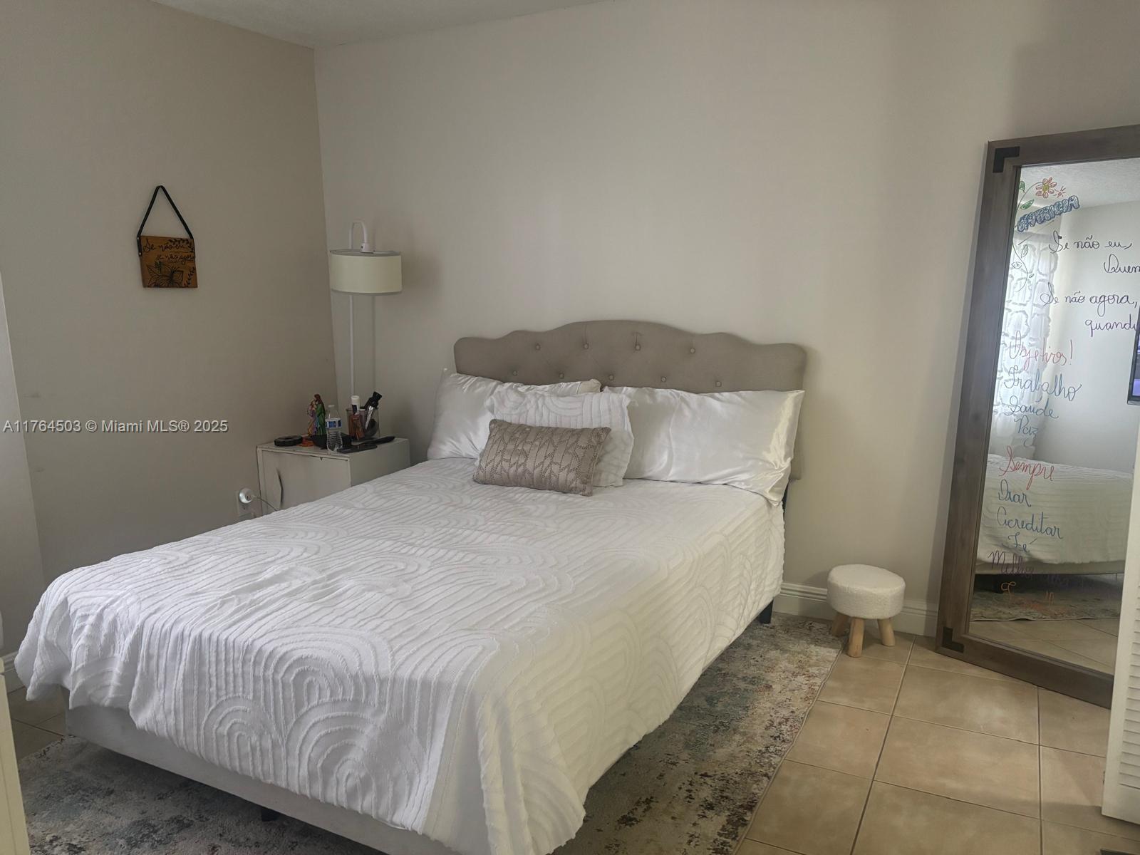 Royal Poinciana Condominium Pompano Beach, FL 33069 - Photo 8 of 11 a large bed sitting in a bedroom next to a window