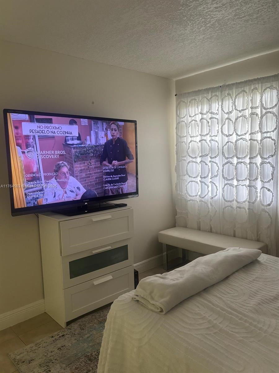 Royal Poinciana Condominium Pompano Beach, FL 33069 - Photo 9 of 11 a bedroom with a bed and a window