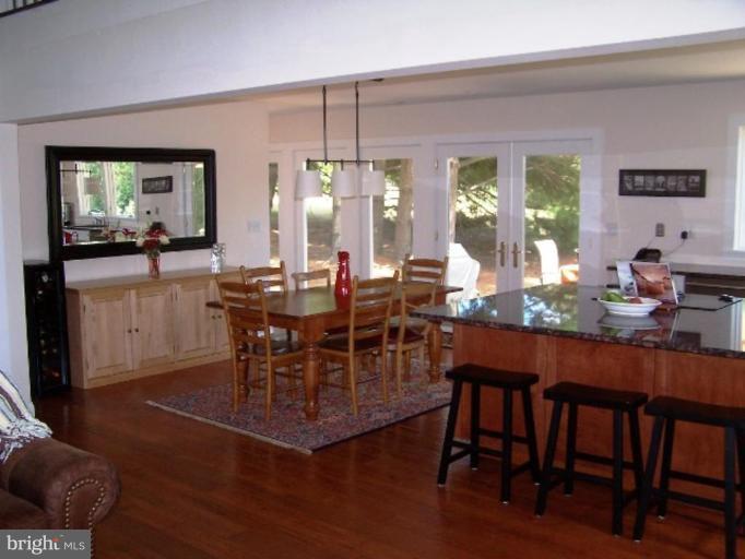 9467 Old Waterloo Road Warrenton, VA 20186 - Photo 2 of 13 a dining room with furniture a chandelier and wooden floor