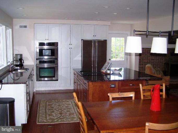 9467 Old Waterloo Road Warrenton, VA 20186 - Photo 3 of 13 a kitchen with stainless steel appliances granite countertop a stove refrigerator sink and cabinets