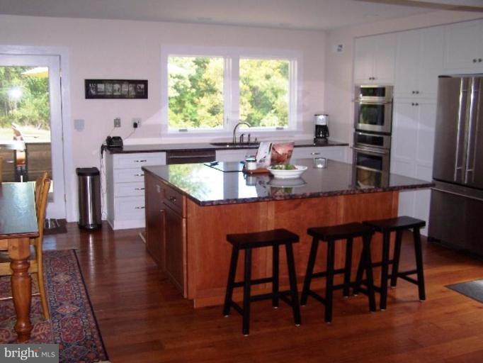 9467 Old Waterloo Road Warrenton, VA 20186 - Photo 4 of 13 a dining room with furniture a window and wooden floor