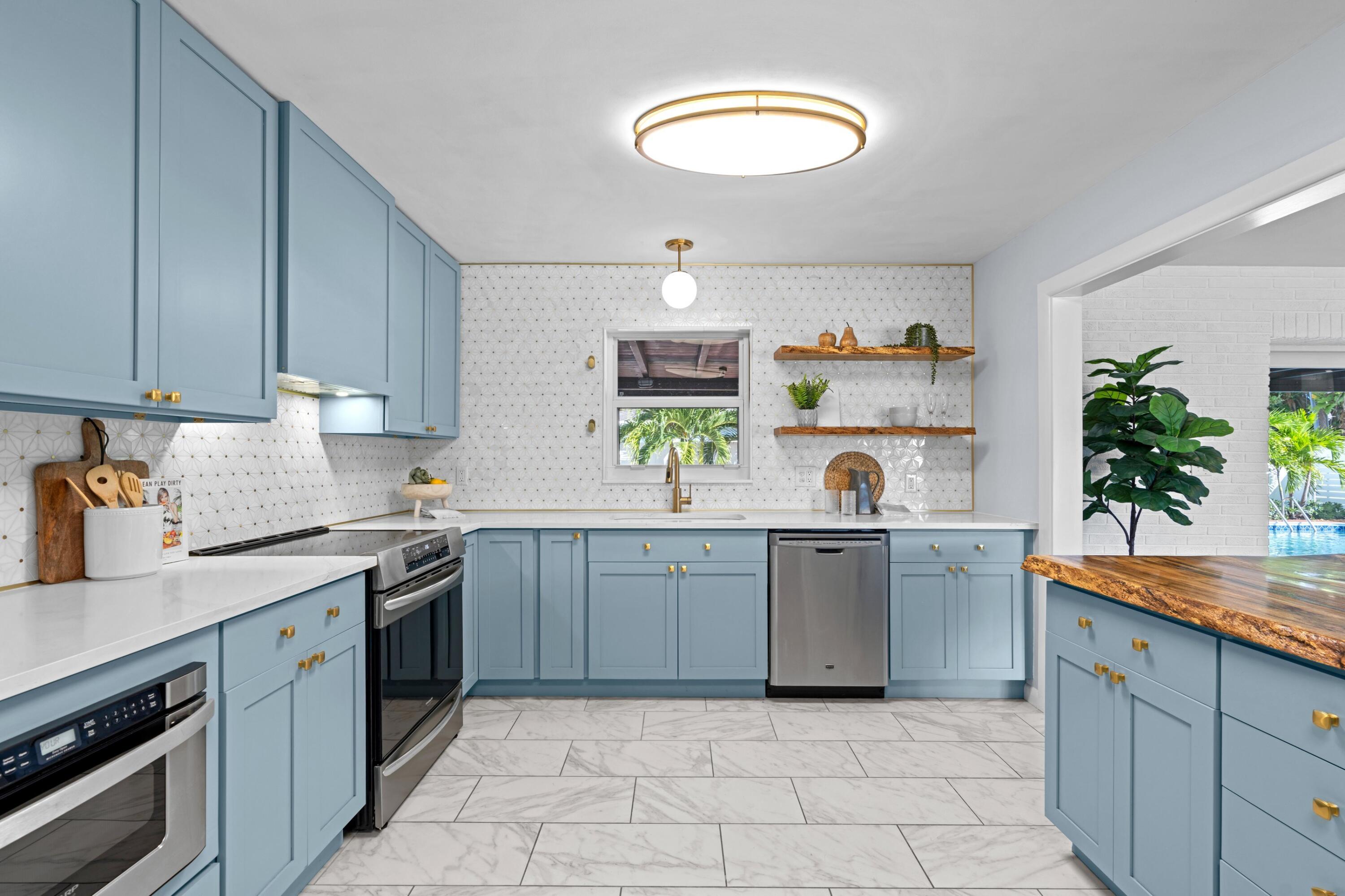 541 Kingfish Road North Palm Beach, FL 33408 - Photo 14 of 43 a kitchen with a sink a stove and cabinets