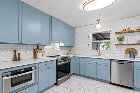 a kitchen with a sink stove and cabinets
