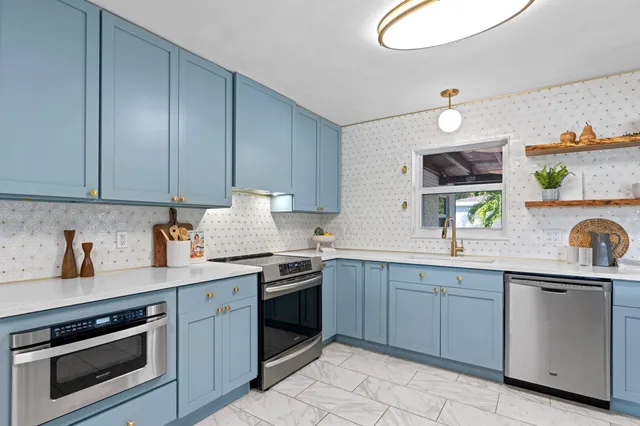 a kitchen with a sink stove and cabinets