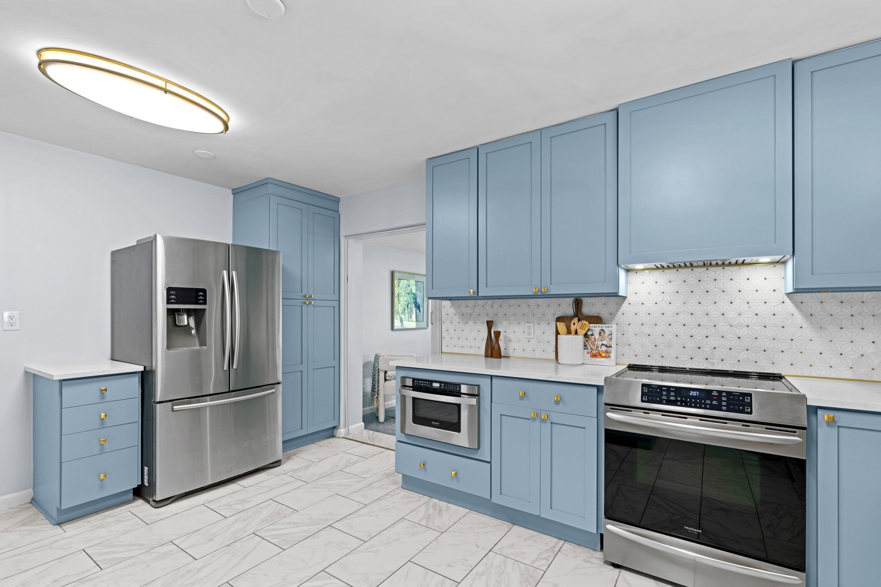 541 Kingfish Road North Palm Beach, FL 33408 - Photo 16 of 43 a kitchen with cabinets stainless steel appliances and a counter space