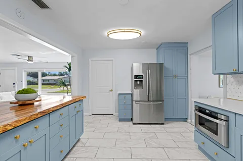 a kitchen with stainless steel appliances granite countertop a refrigerator and a sink