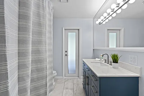 a bathroom with a sink a vanity and a mirror