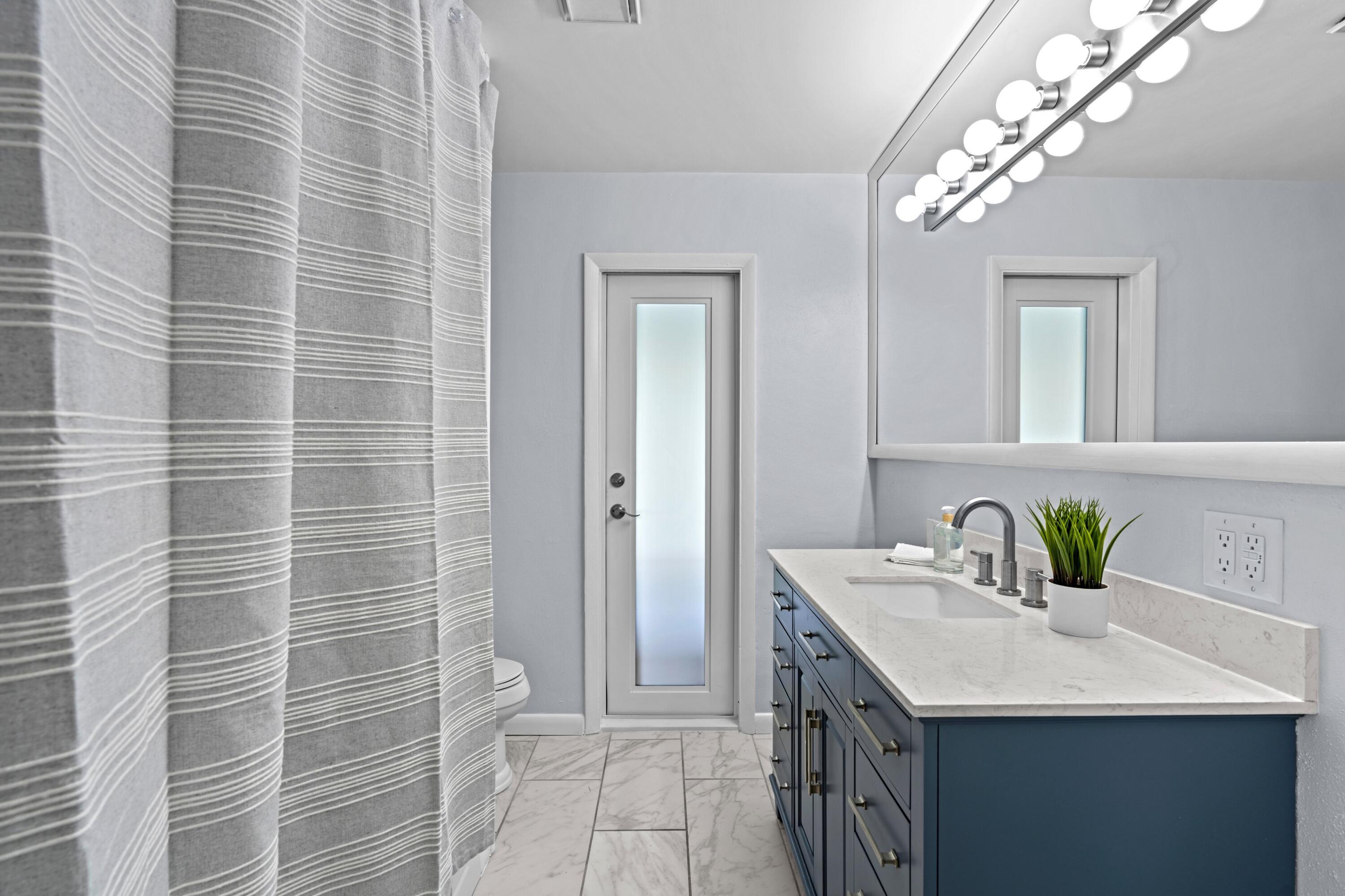 541 Kingfish Road North Palm Beach, FL 33408 - Photo 23 of 43 a bathroom with a sink a vanity and a mirror