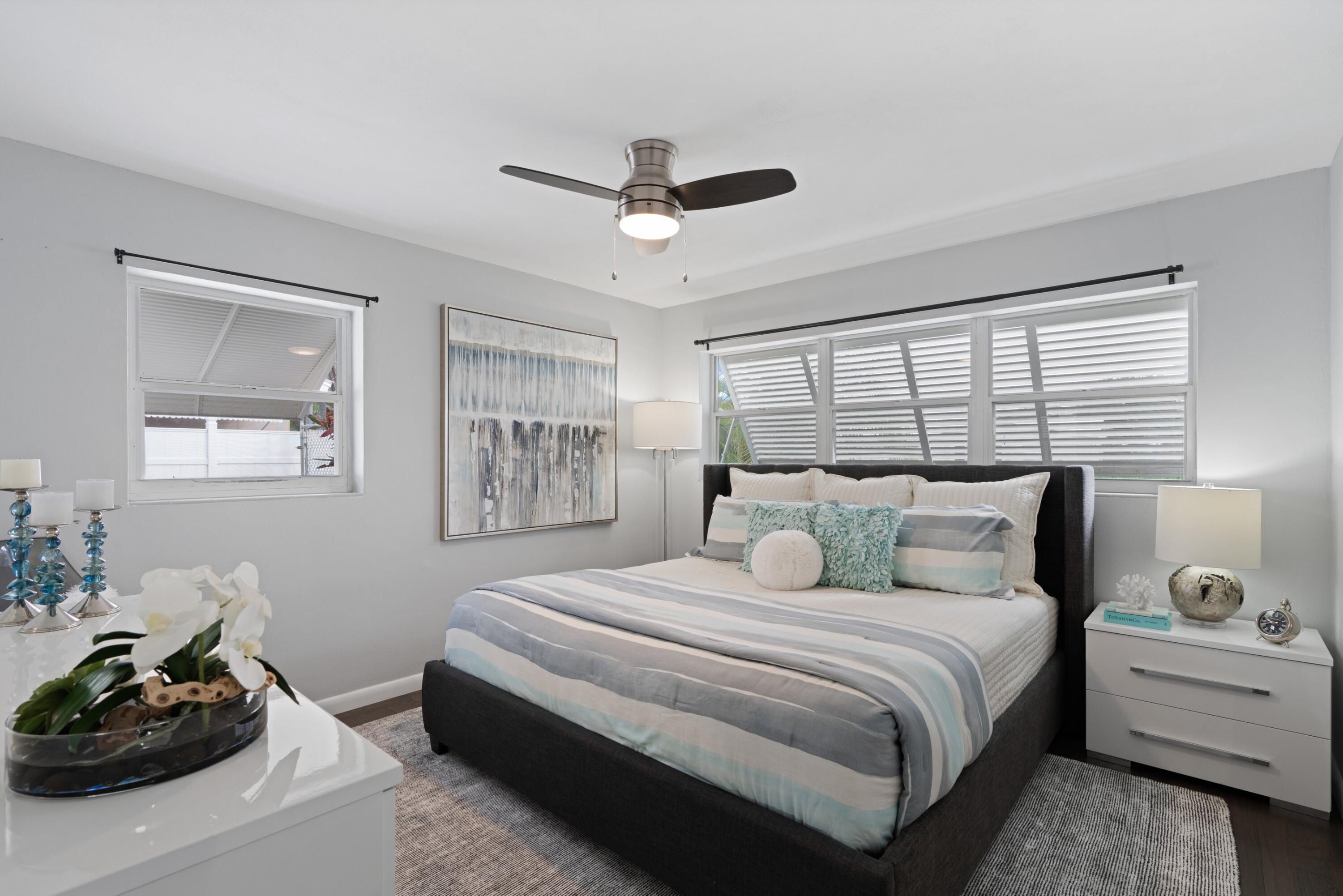 541 Kingfish Road North Palm Beach, FL 33408 - Photo 25 of 43 a bedroom with a bed and wooden floor