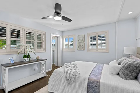 a bedroom with a bed a dresser next to a window