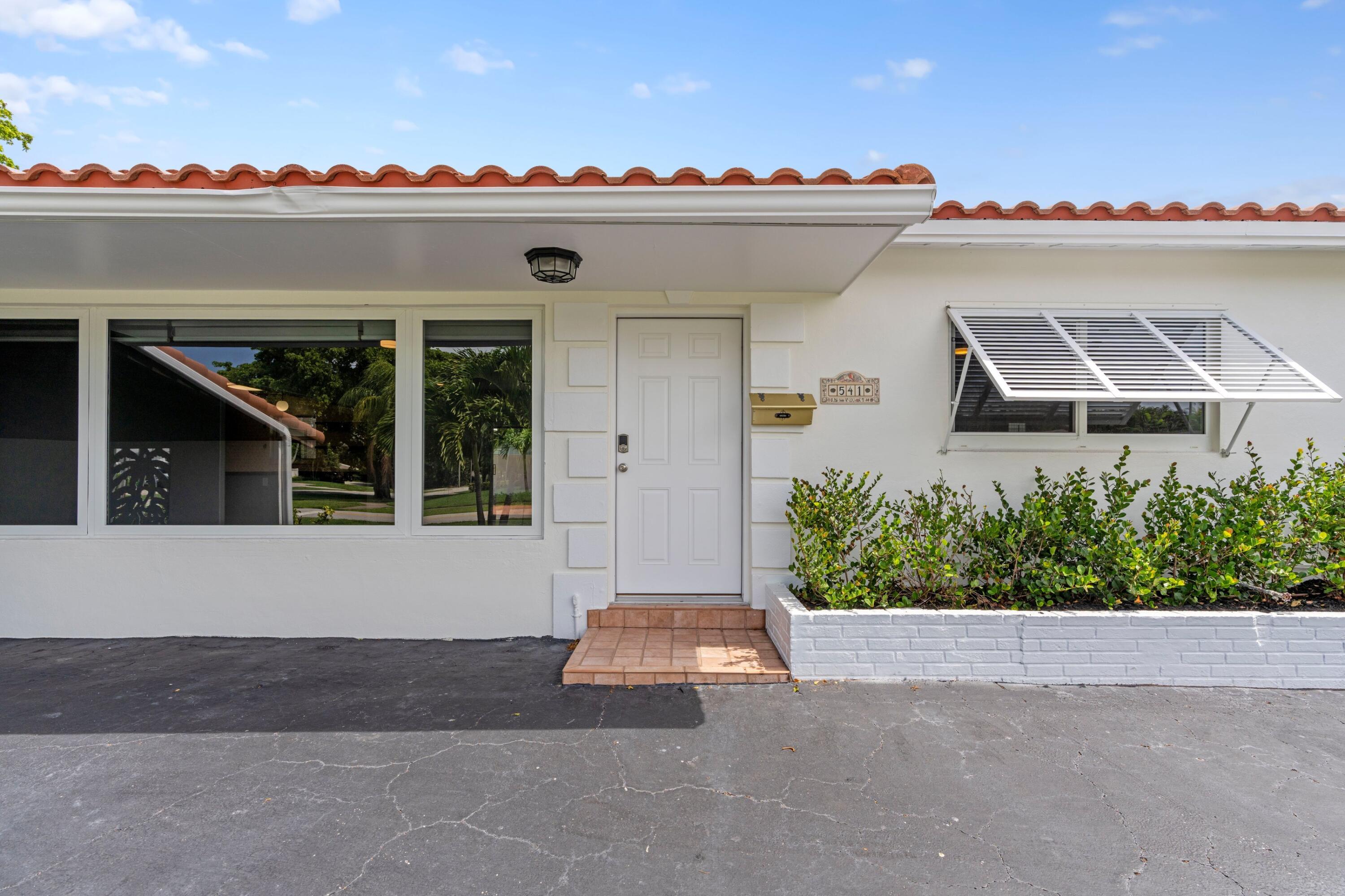541 Kingfish Road North Palm Beach, FL 33408 - Photo 3 of 43 a view of house and a yard