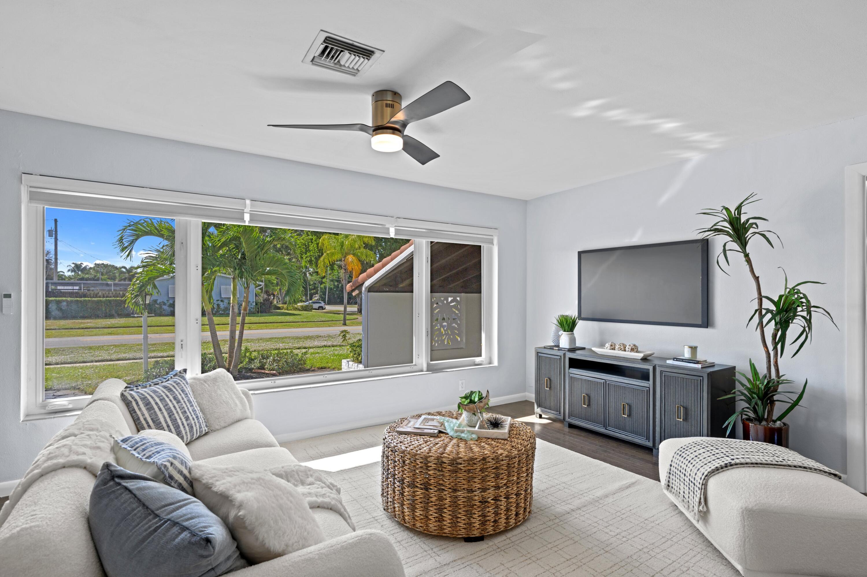 541 Kingfish Road North Palm Beach, FL 33408 - Photo 7 of 43 a living room with furniture and a flat screen tv