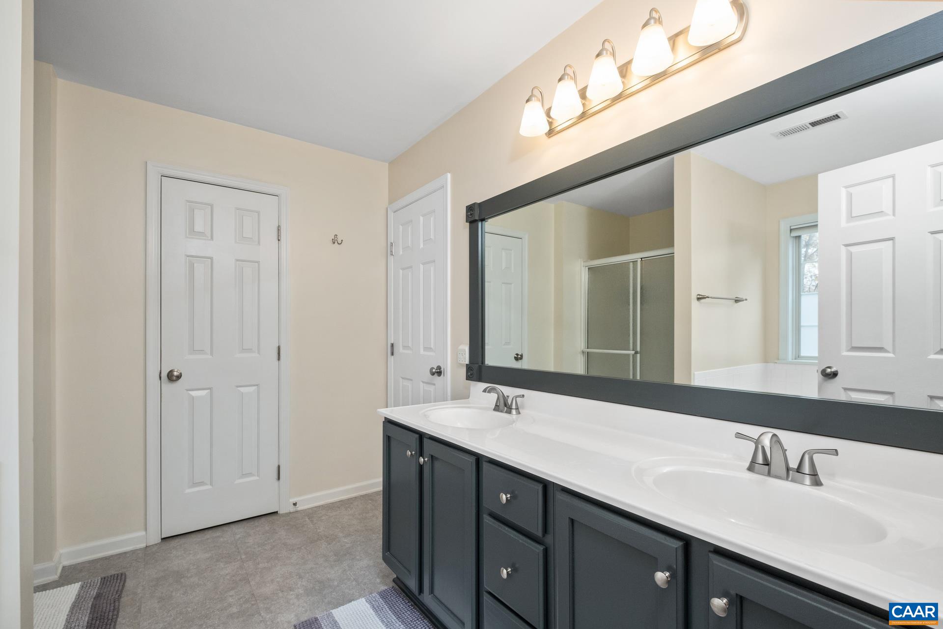 500 Northridge Road Ruckersville, VA 22968 - Photo 29 of 42 a bathroom with a double vanity sink and a mirror