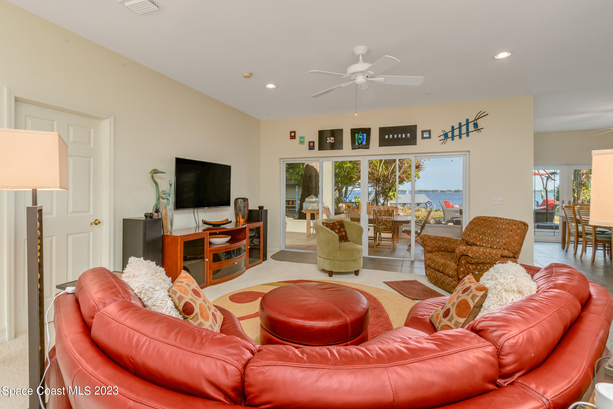 4553 Coquina Ridge Drive Melbourne, FL 32935 - Photo 12 of 51 a living room with furniture and a flat screen tv
