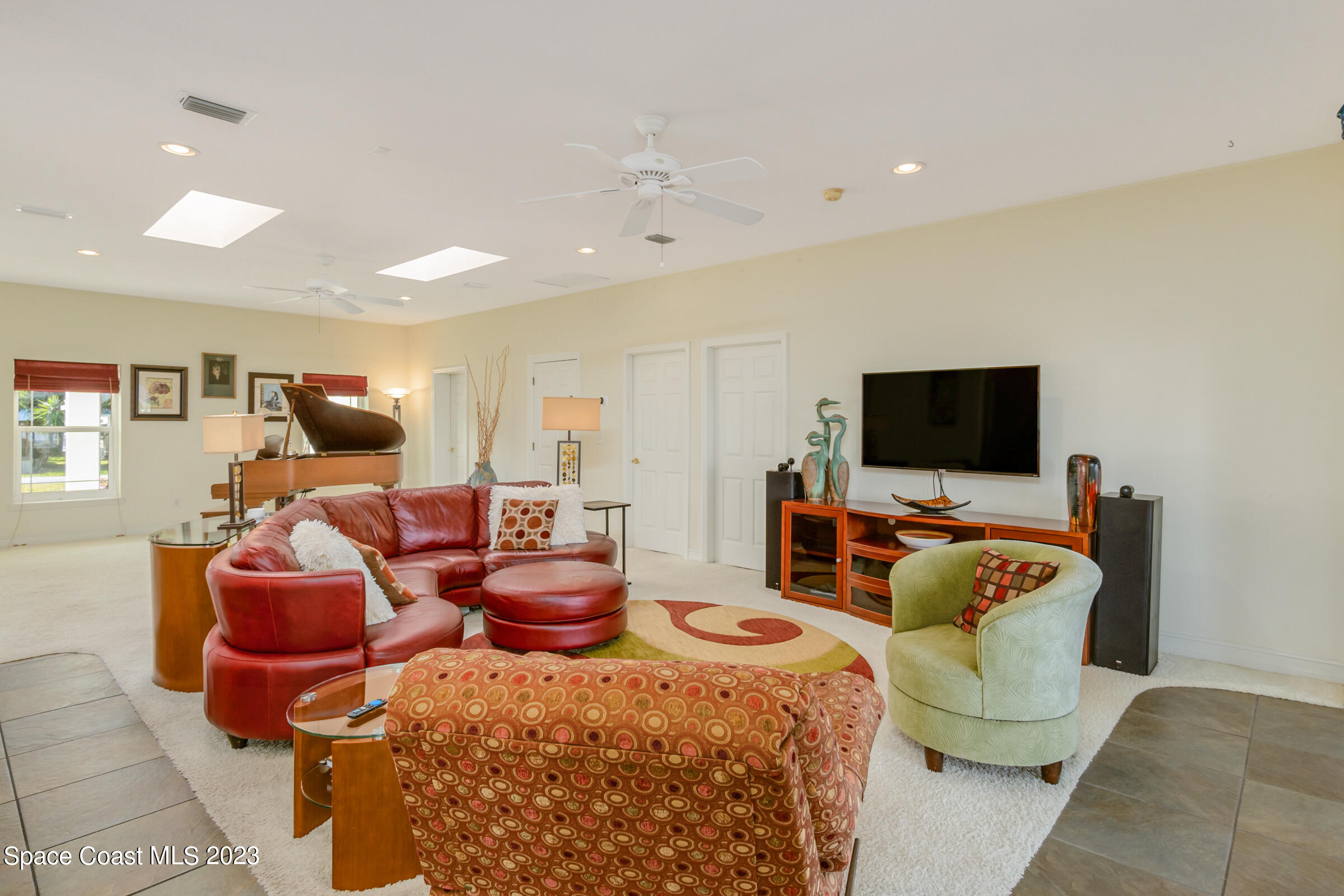 4553 Coquina Ridge Drive Melbourne, FL 32935 - Photo 13 of 51 a living room with furniture and a flat screen tv