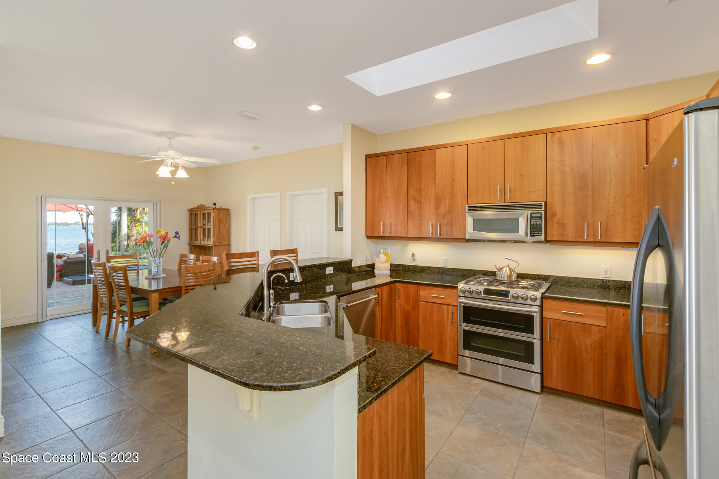 4553 Coquina Ridge Drive Melbourne, FL 32935 - Photo 16 of 51 a kitchen with stainless steel appliances granite countertop a sink a stove and cabinets