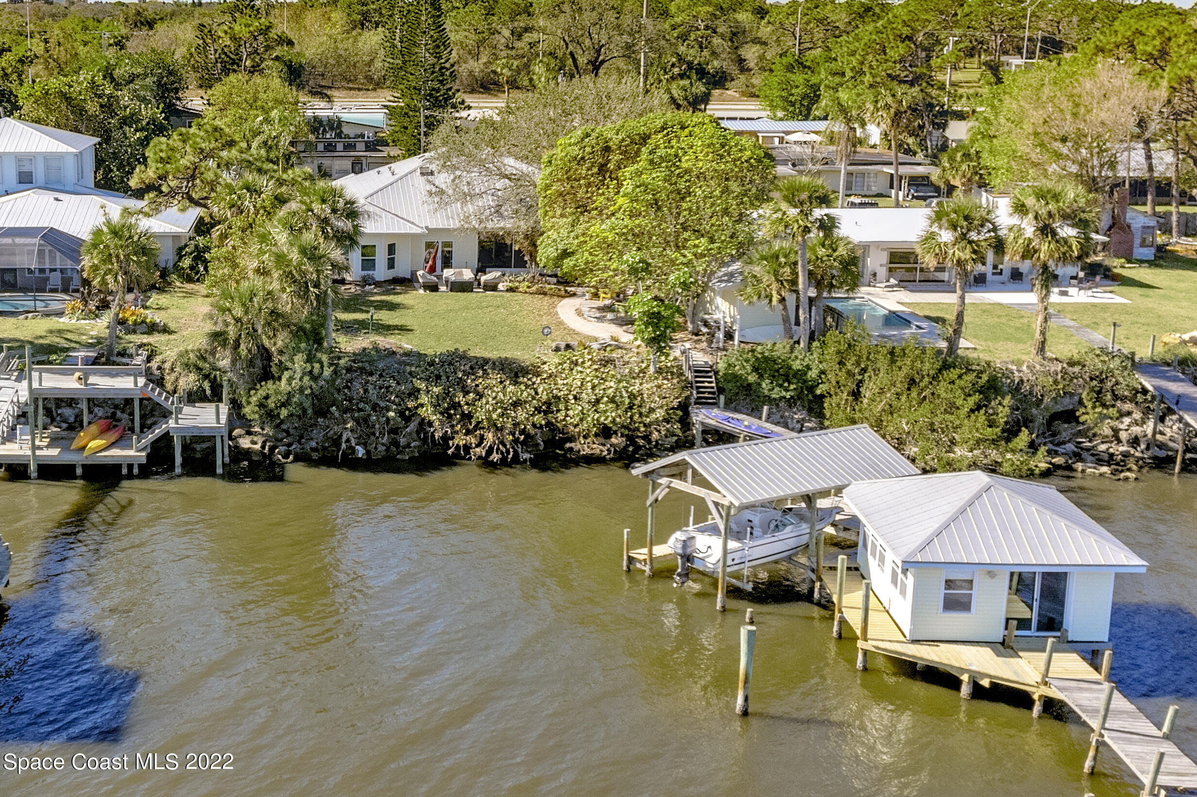 4553 Coquina Ridge Drive Melbourne, FL 32935 - Photo 2 of 51 an aerial view of a house with swimming pool patio and lake view