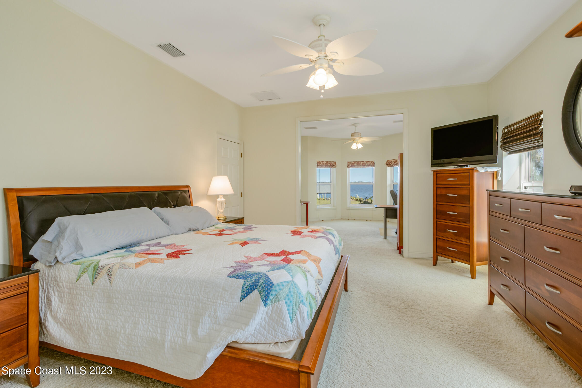 4553 Coquina Ridge Drive Melbourne, FL 32935 - Photo 21 of 51 a bedroom with a bed and a television
