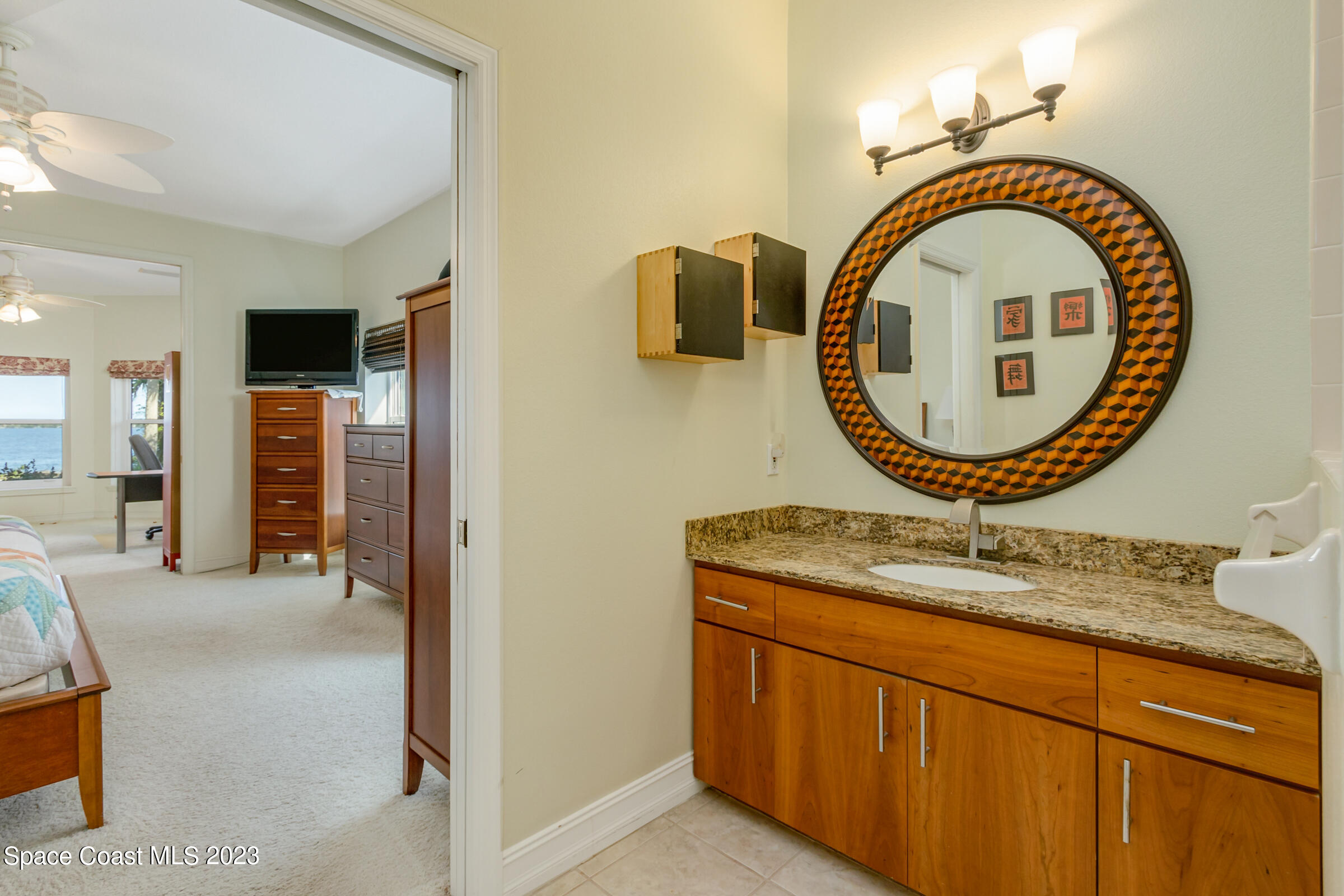 4553 Coquina Ridge Drive Melbourne, FL 32935 - Photo 23 of 51 a bathroom with a sink and a mirror