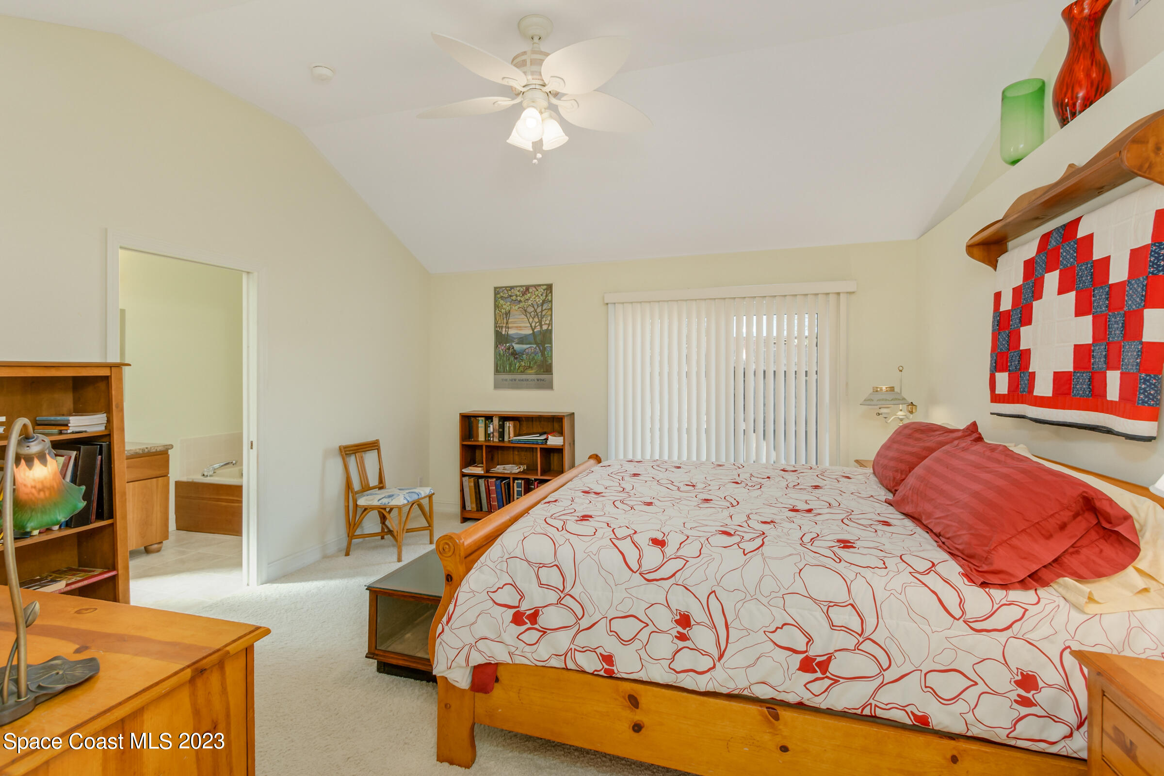 4553 Coquina Ridge Drive Melbourne, FL 32935 - Photo 29 of 51 a bedroom with a bed and a flat screen tv