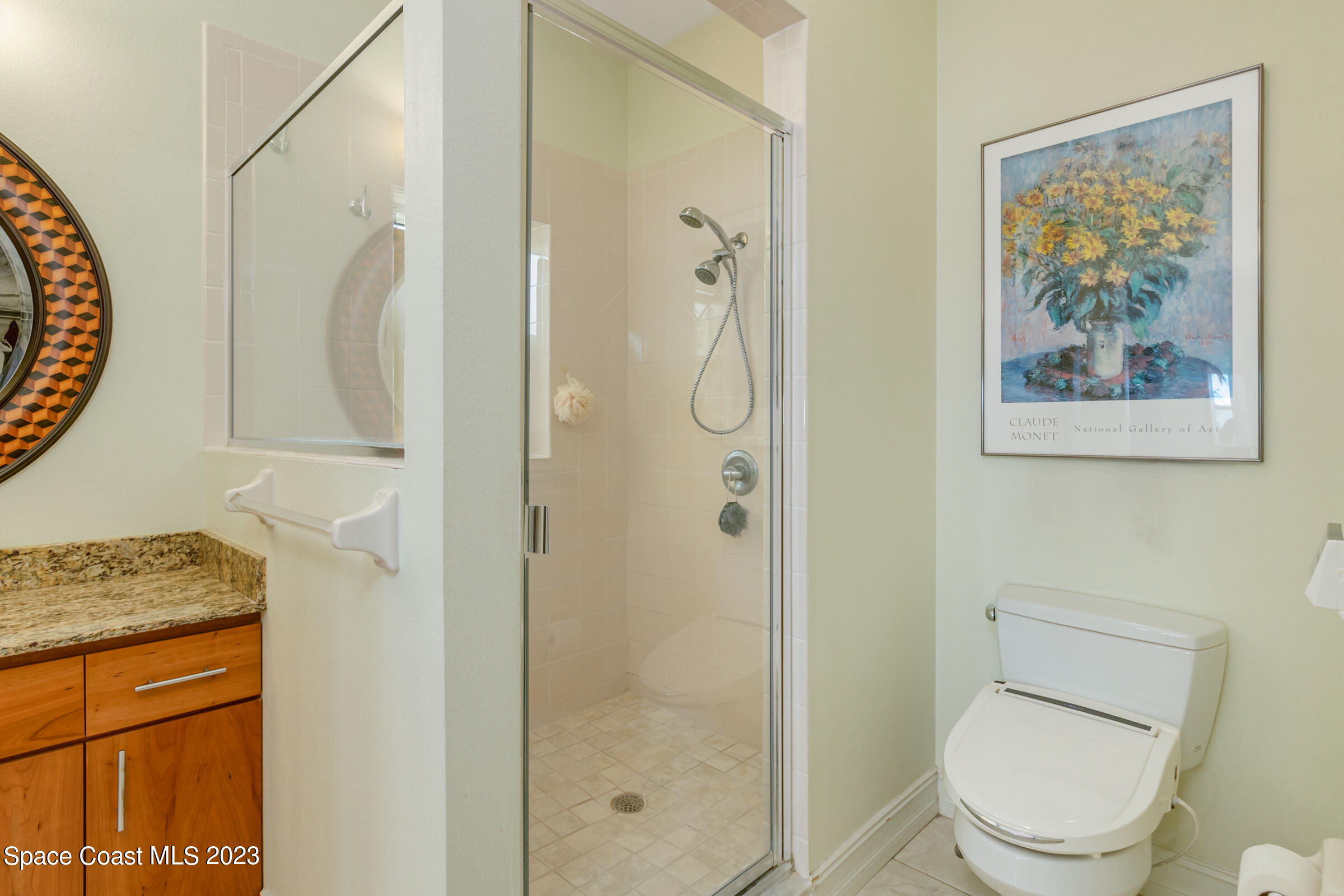 4553 Coquina Ridge Drive Melbourne, FL 32935 - Photo 30 of 51 a bathroom with a granite countertop shower a toilet and a sink