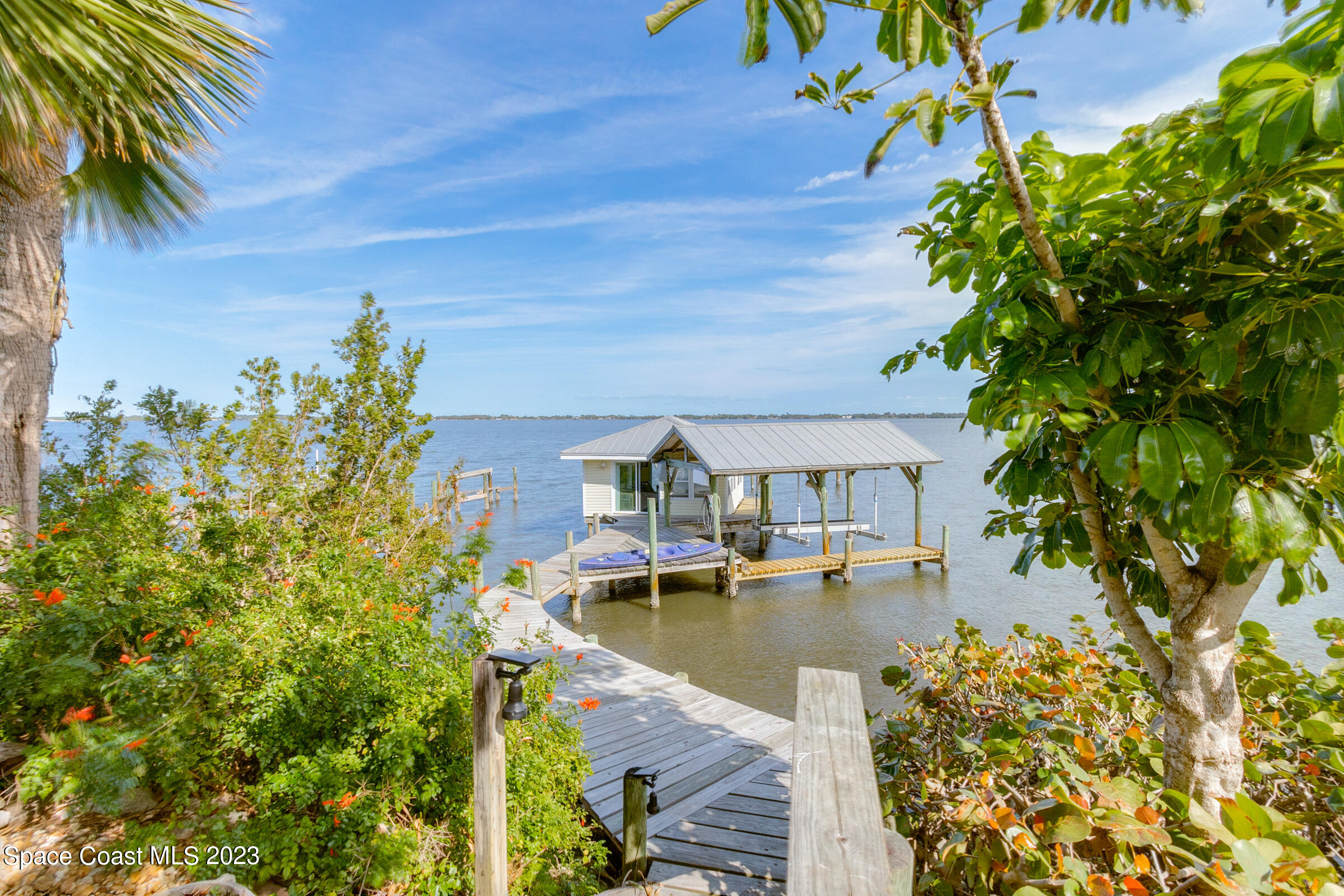 4553 Coquina Ridge Drive Melbourne, FL 32935 - Photo 43 of 51 a view of a lake with a house in the background