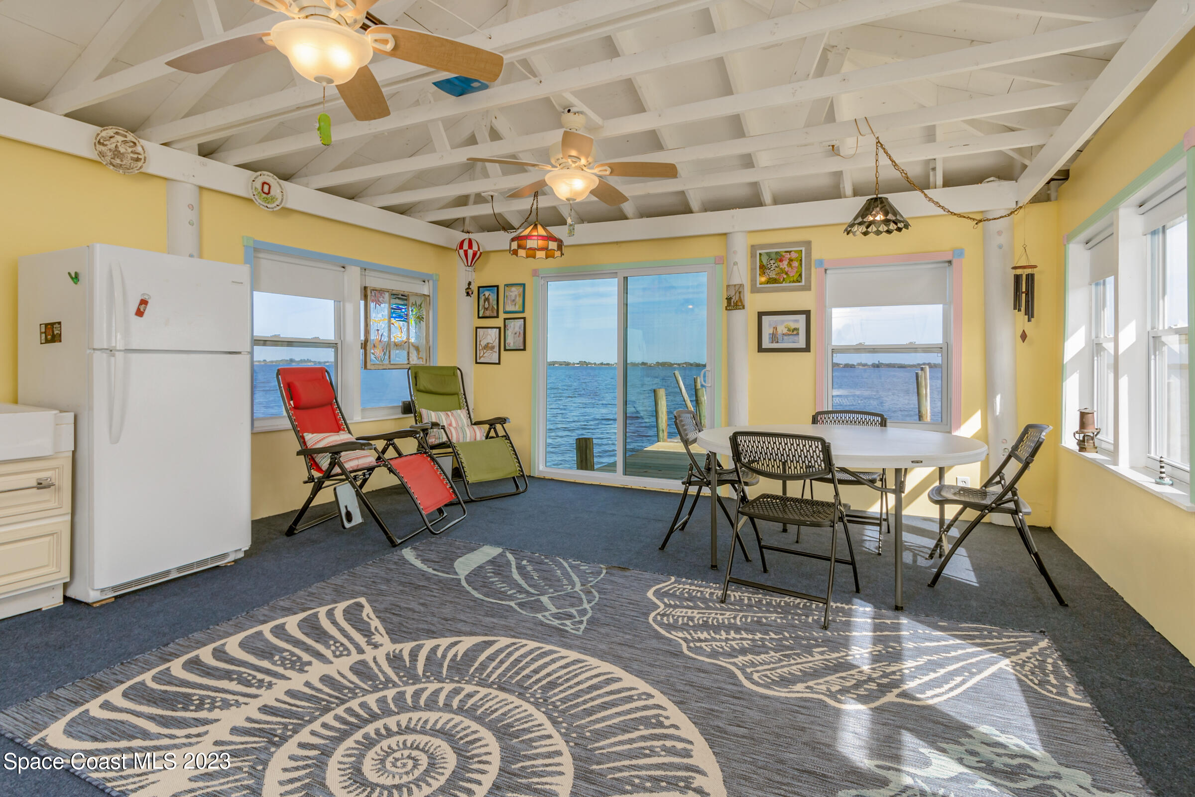 4553 Coquina Ridge Drive Melbourne, FL 32935 - Photo 44 of 51 a living room with furniture and a chandelier