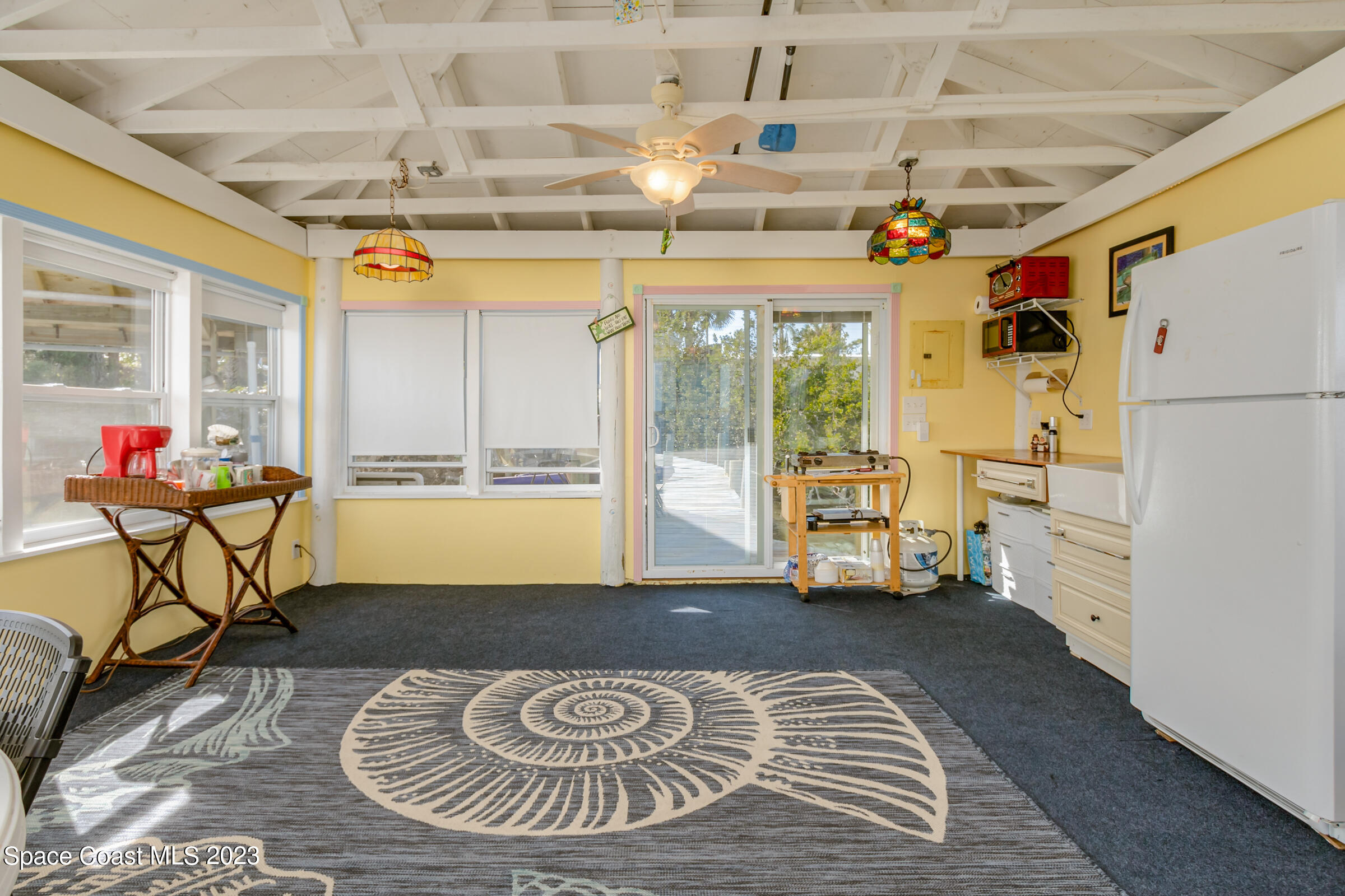 4553 Coquina Ridge Drive Melbourne, FL 32935 - Photo 45 of 51 a view of a dining room with furniture a chandelier and a rug