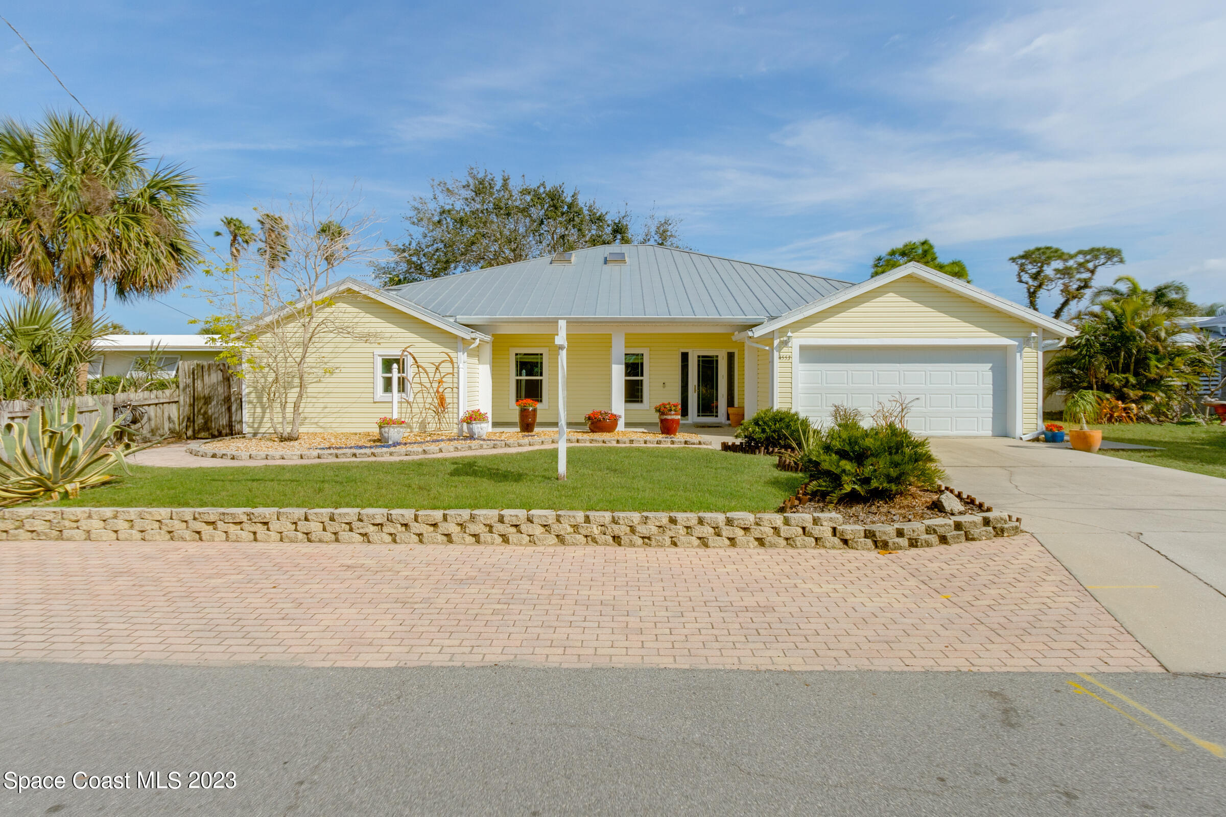 4553 Coquina Ridge Drive Melbourne, FL 32935 - Photo 6 of 51 a front view of a house with a garden