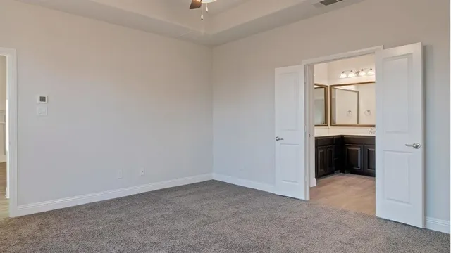 a view of a hallway with wooden floor and entryway
