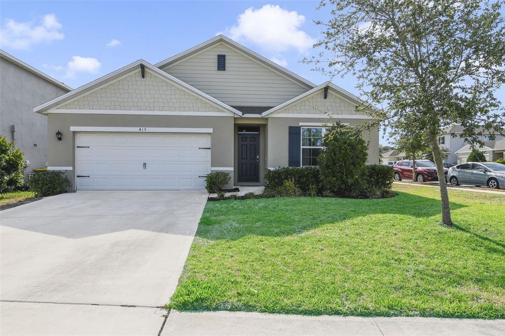 415 Anne Street DeLand, FL 32724 - Photo 1 of 1 a front view of house with a yard and trees