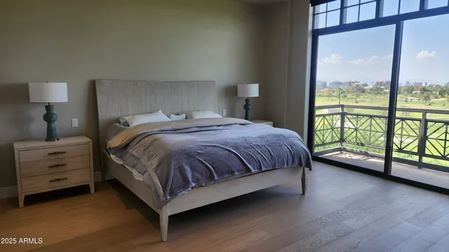 a bedroom with a bed and a large window