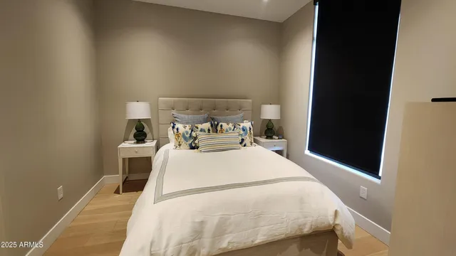 a large bed sitting in a bedroom next to a window