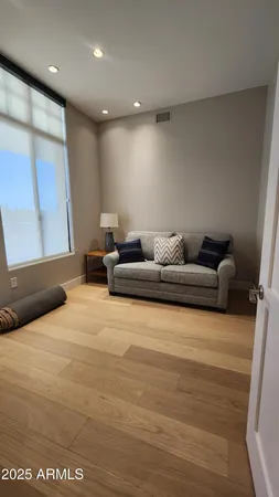 a living room with furniture window and a wooden floor