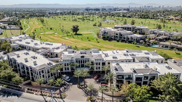 a view of a city with lawn chairs and ocean view