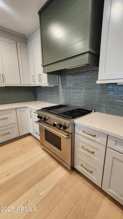 a kitchen with granite countertop white cabinets and white appliances