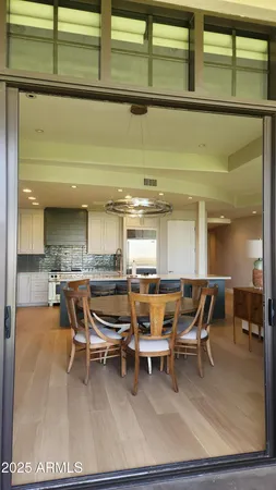 a dining area with furniture and a rug