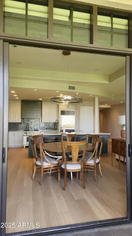 a dining area with furniture and a rug