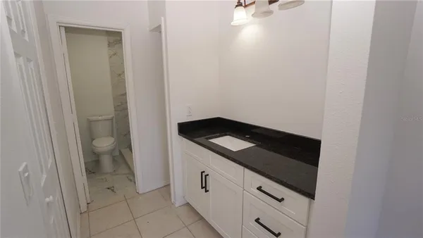 a white toilet sitting next to a shower